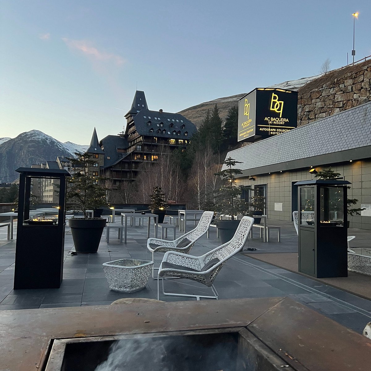Hotel terrace at dusk with mountain views
