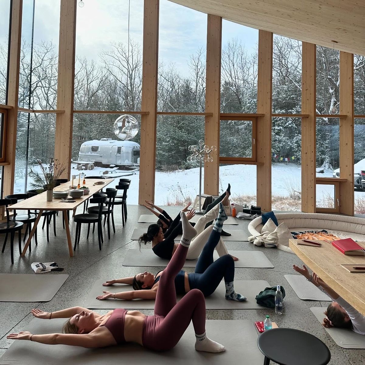 Women moving together in a light-filled winter space
